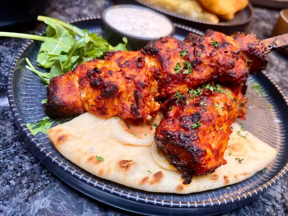 Harissa chicken skewers at Say When — chargrilled harissa chicken on warm flatbread with rocket and minted yoghurt